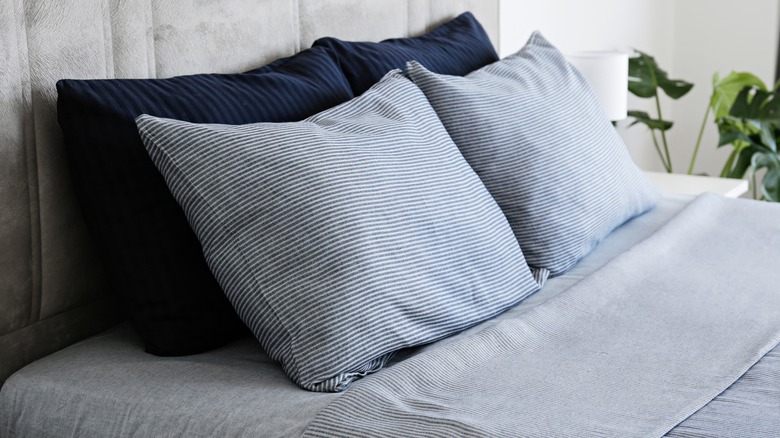 Blue striped pillows against headboard