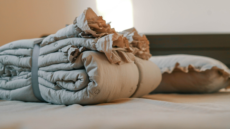 A new folded comforter with a ruffle.