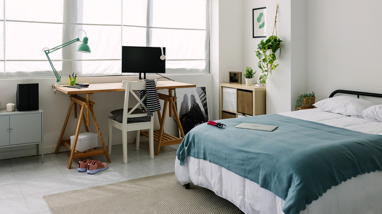 spacious bedroom with bed and desk