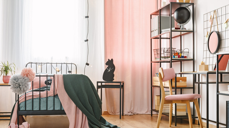 Modern bedroom with matching bed frame, side table, bookshelf and vanity.