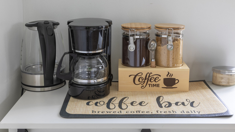 Coffee bar set up with coffee maker and containers for sugar