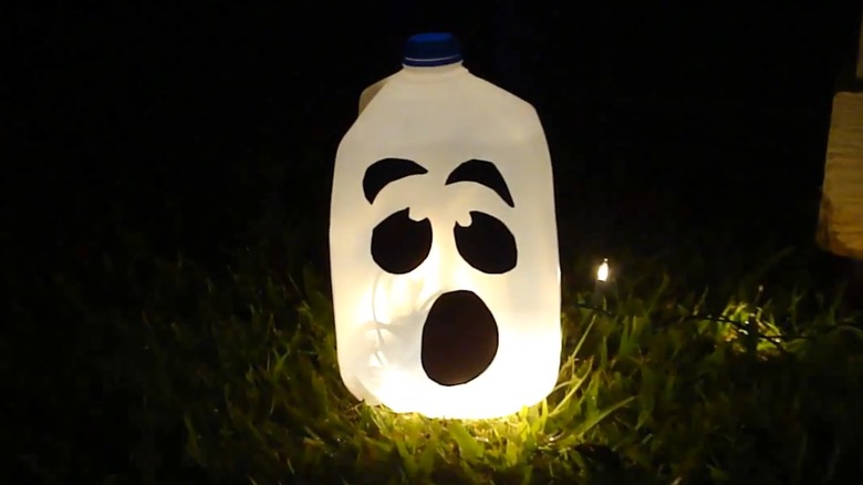 kids sitting a table crafting while wearing Halloween costumes