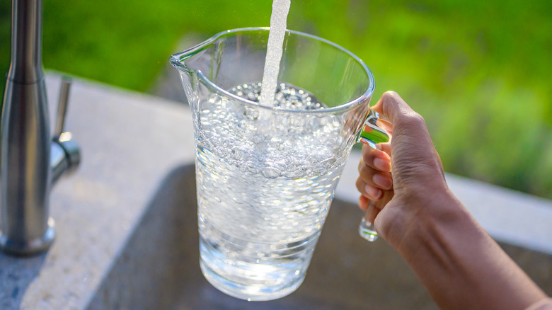 filling up jug of water 