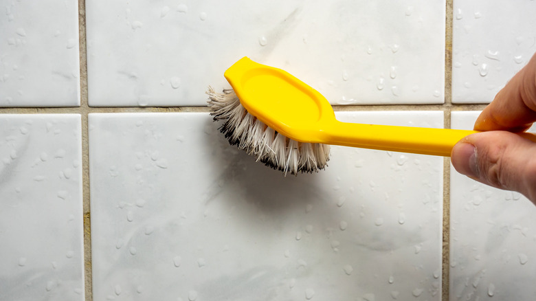 Person cleaning grout