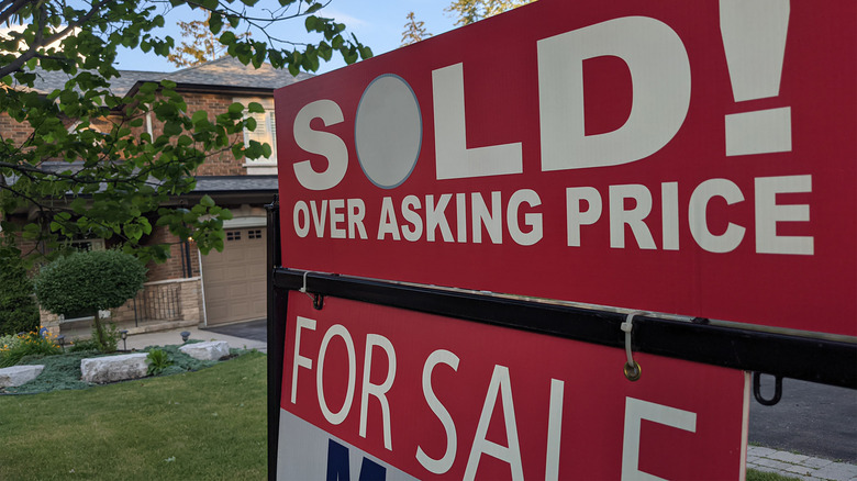 sold sign in front of house