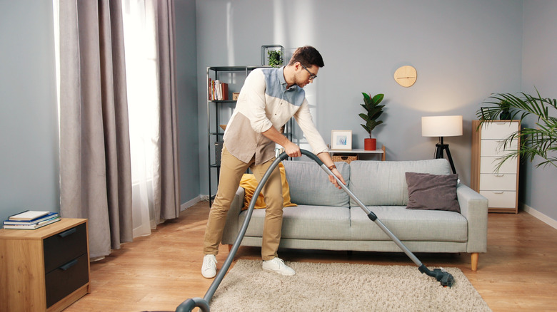 person cleaning house
