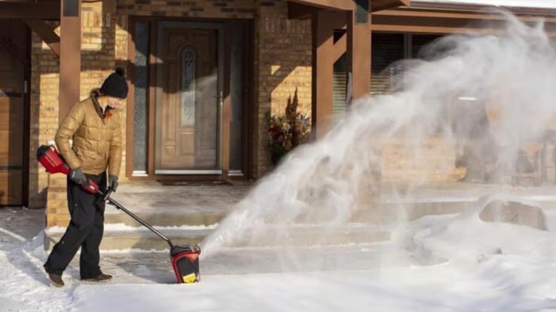 Person using a Toro power snow shovel