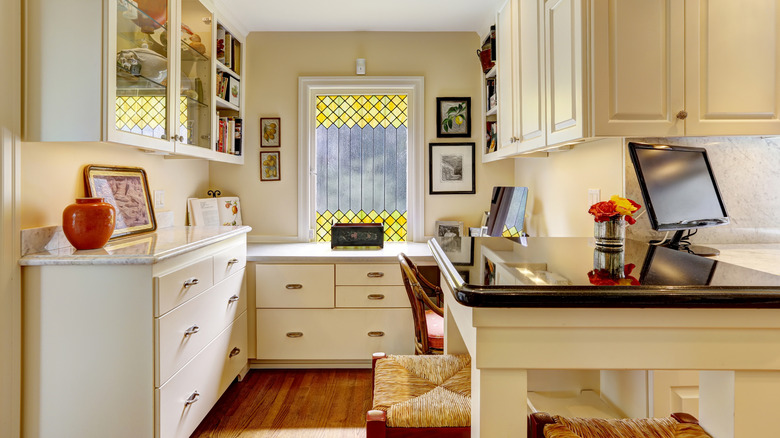 Cozy office area with white cabinets in kitchen room