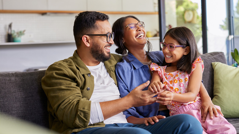 Happy family sitting on couch together