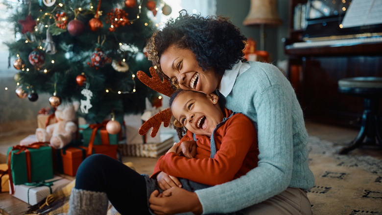 Mother and Child on Christmas morning next to tree