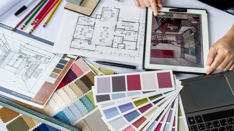 Top view of architects/ interior designer hands working with tablet