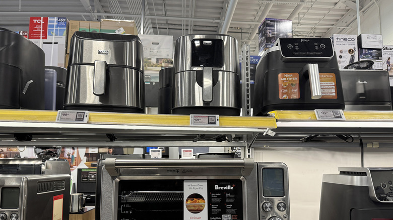 Variety of air fryers on shelves in a store