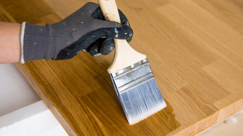 Painting wooden countertop with brush