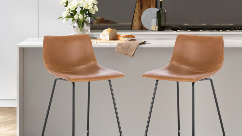 two tan leather stools