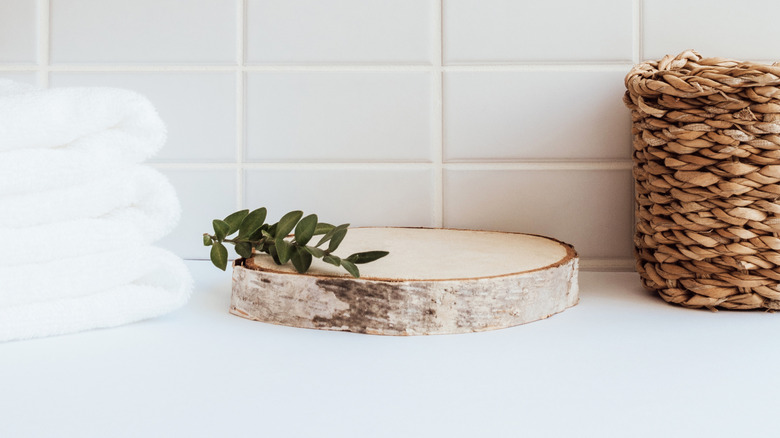 White bathroom countertop with towels and basket on top
