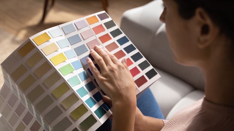 Woman holding paint swatches