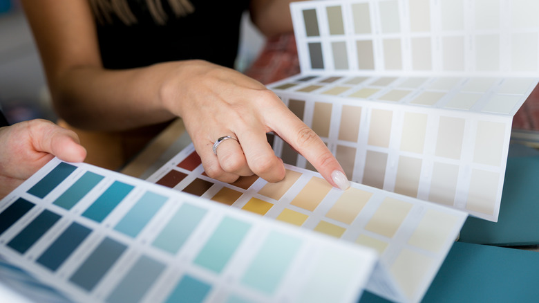 woman looking at paint color swatches