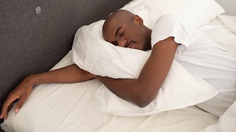 man sleeping comfortably in bed