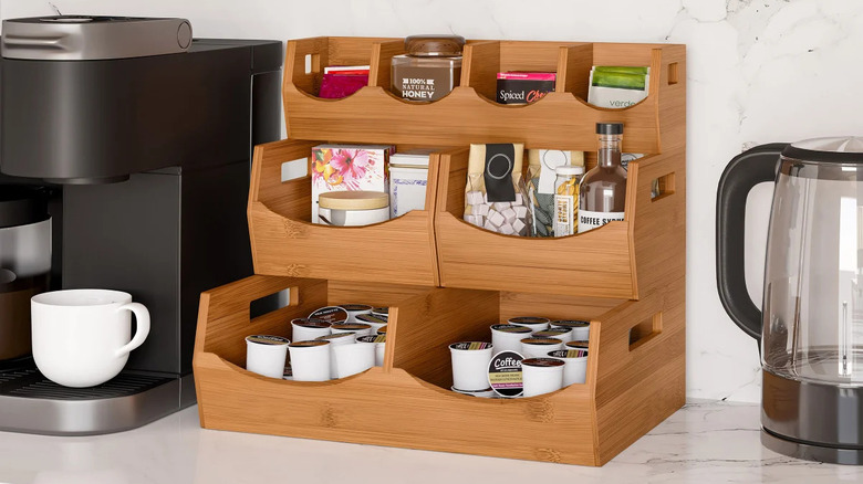 A bamboo organizer holding coffee supplies and is placed on a kitchen countertop