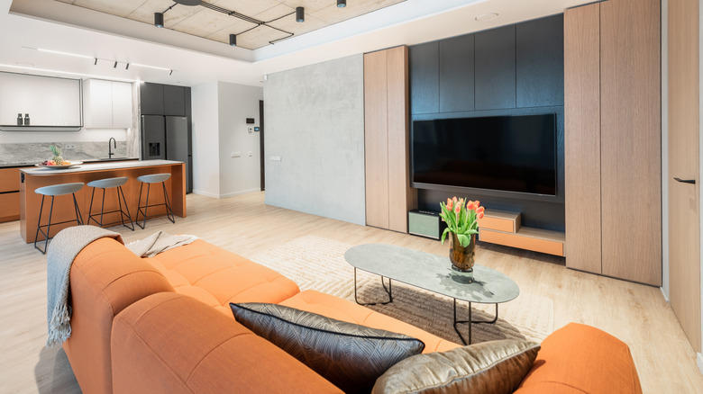 Living room with an orange sofa and light wood