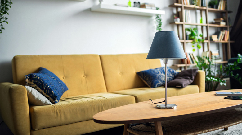 yellow couch with blue accents in small living room