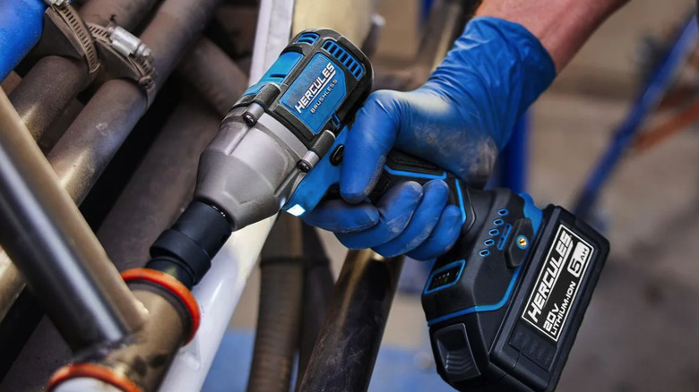 gloved hand using a Hercules impact drill with a 20v 5Ah battery