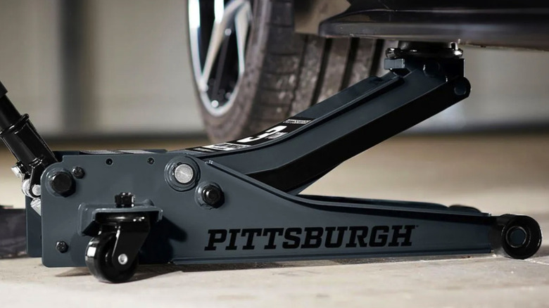 Pittsburgh floor jack in a garage lifting a vehicle
