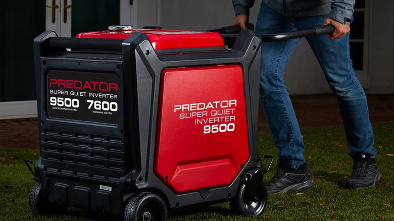 Man pushing the 9500 watt predator generator across a lawn in front of a house