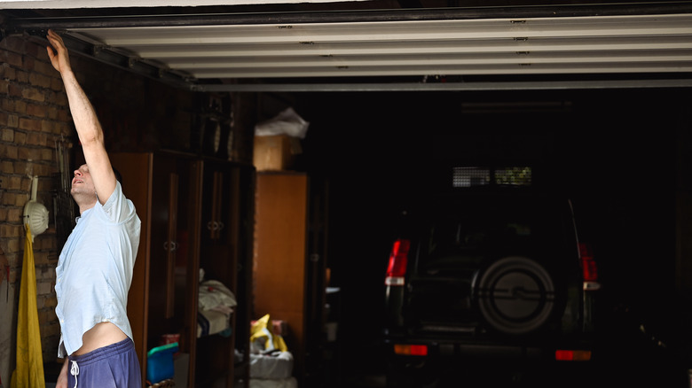 man checking garage door tracks