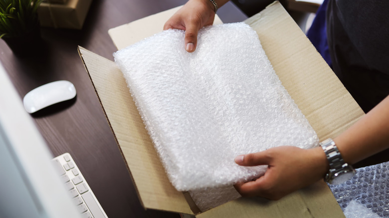 person removing bubble wrap