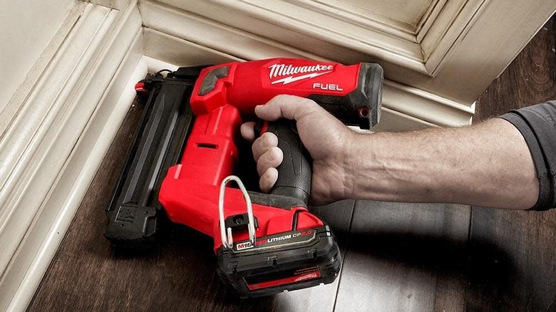 Milwaukee brad nailer in action