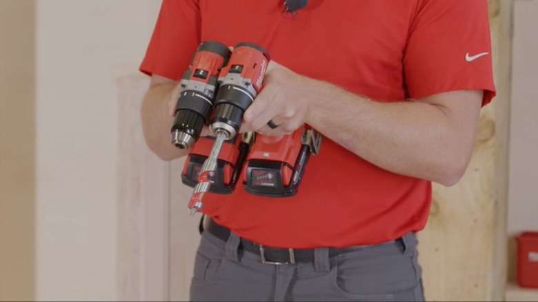 Man holding drill and driver