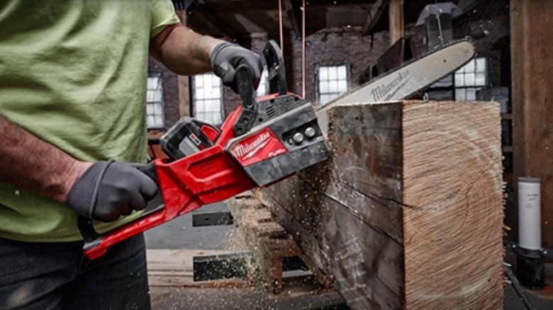 Man using Milwaukee M18 chainsaw