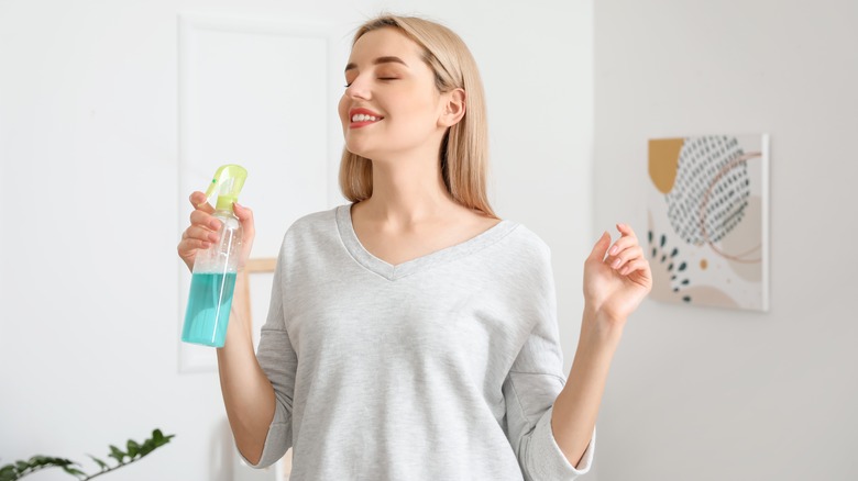 Woman holding spray bottle