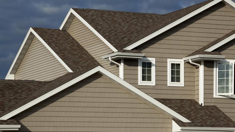 A light brown house with a dark brown roof.