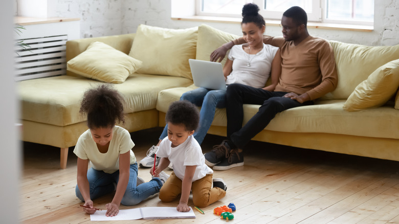 young family relaxing in apartment