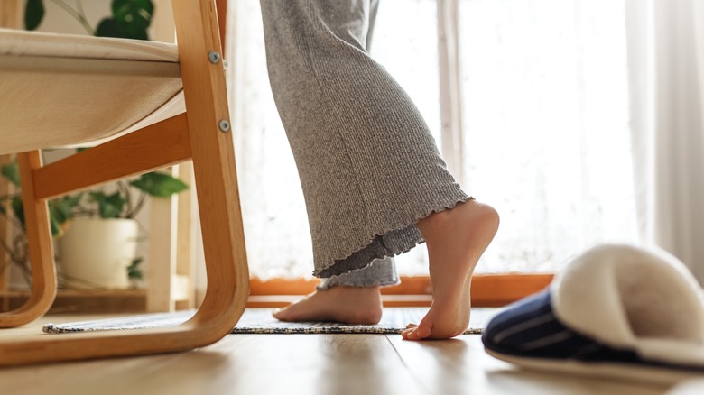 Woman walking barefoot on rug