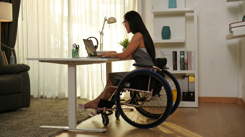 woman in wheelchair working from home