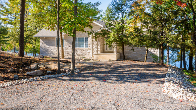 Gravel driveway leading to a house