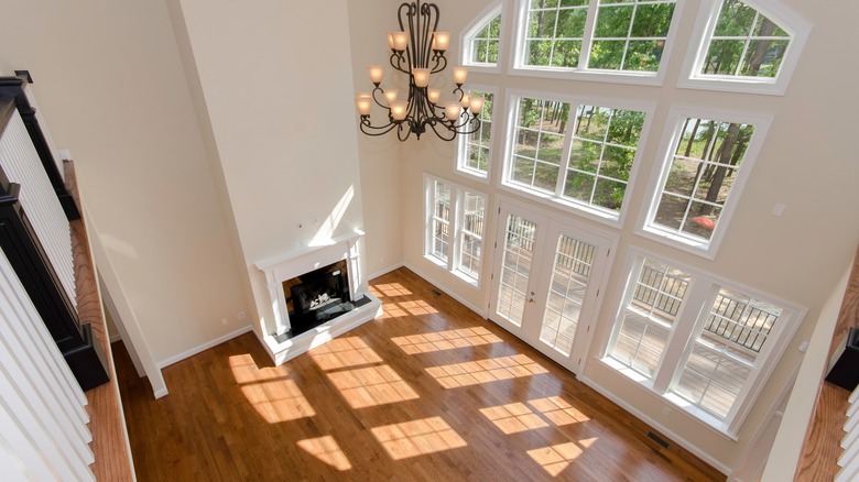 An empty living room with large windows