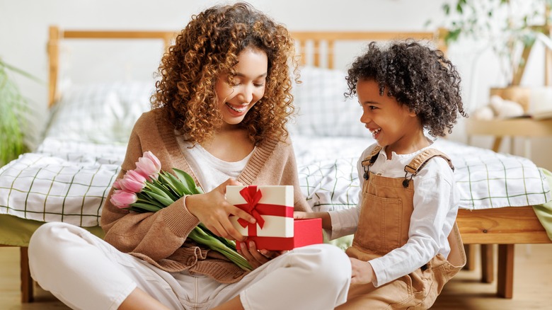 Mother and child opening gifts