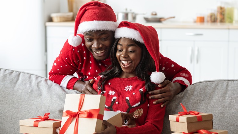 Father and daughter opening gift