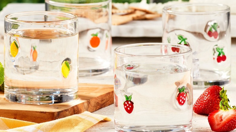 A set of Pandex Icon Glasses with a different fruit motif fused into each tumbler on a patio table.