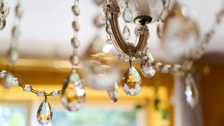 A close up of some of the decorative pieces of a chandelier, including the dangling glass pieces