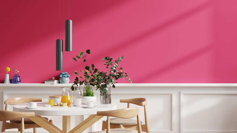 Corner of a room with magenta chair and plants