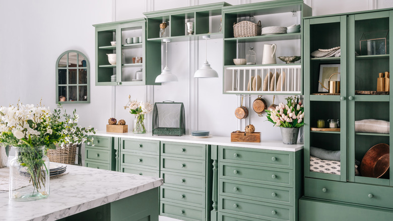 Bright kitchen with green cabinetry