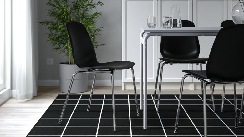 Black and chrome IKEA dining chairs around a table