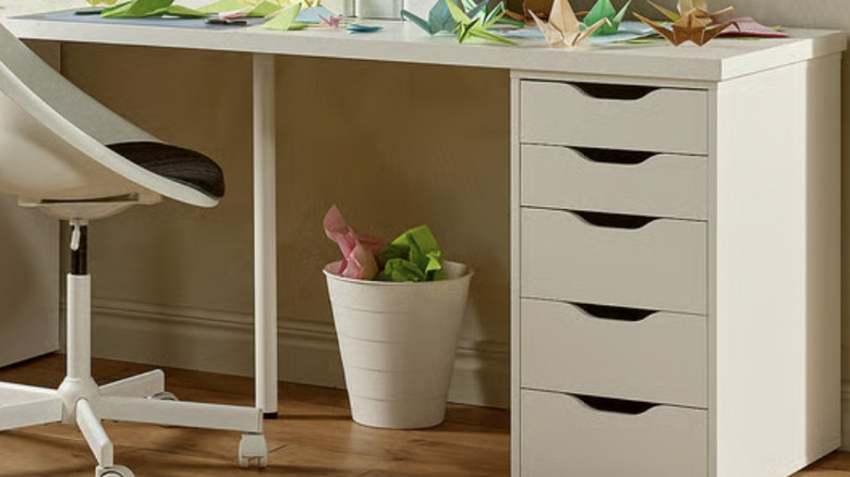 ALEX drawers being used as a desk support with paper cranes on top
