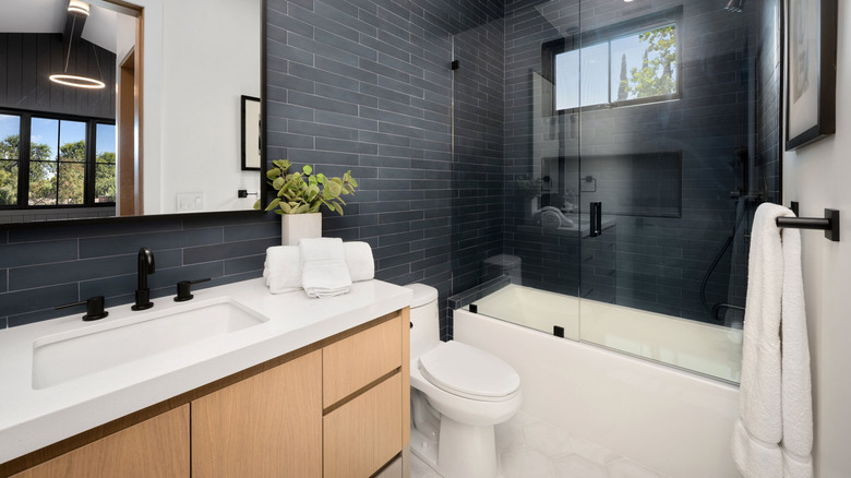 A modern bathroom with a large mirror.