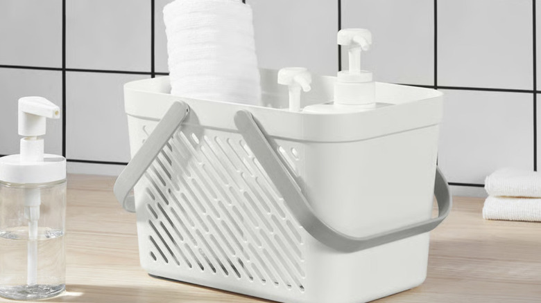 IKEA RÅNEN basket on a bathroom countertop with pumps and a towel inside